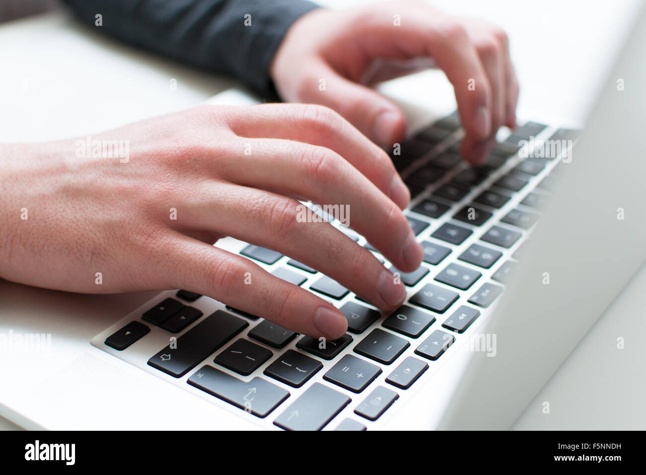 Man typing on his laptop Stock Photo
