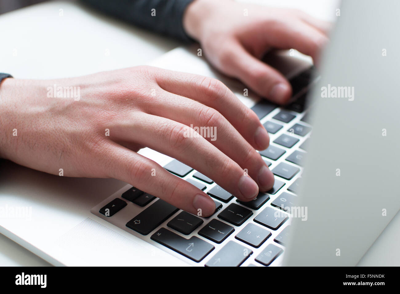 Man typing on his laptop Stock Photo
