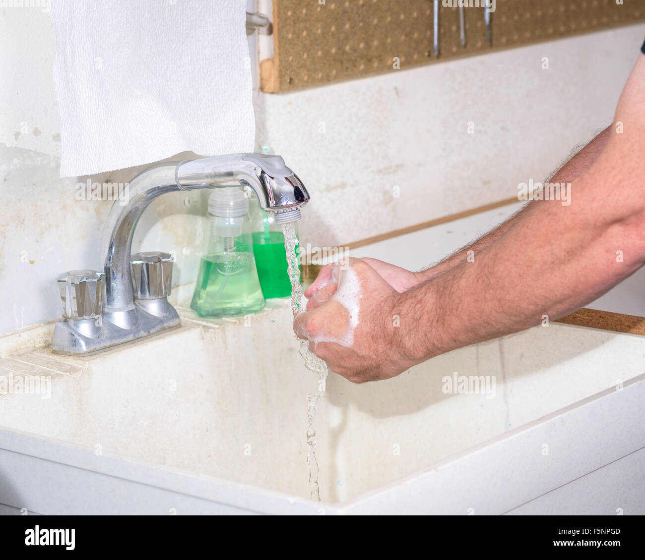 Washing hands in a utility sink Stock Photo Alamy