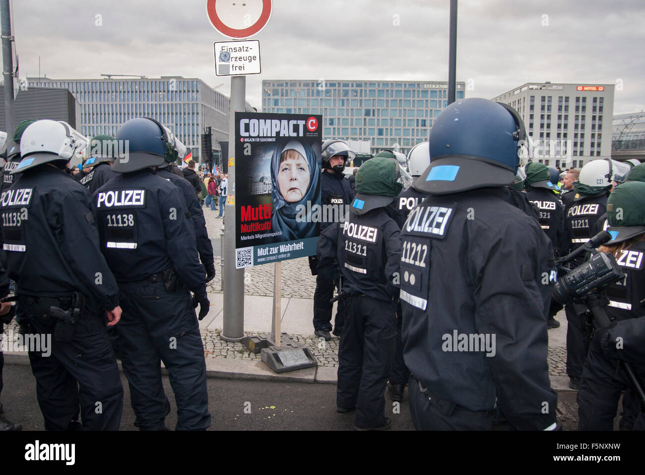 Berlin, Germany. 07th Nov, 2015. Demonstration by German party AfD in Berlin, Germany. A sign showing Angela Merkel and a group of Police officers. Stock Photo