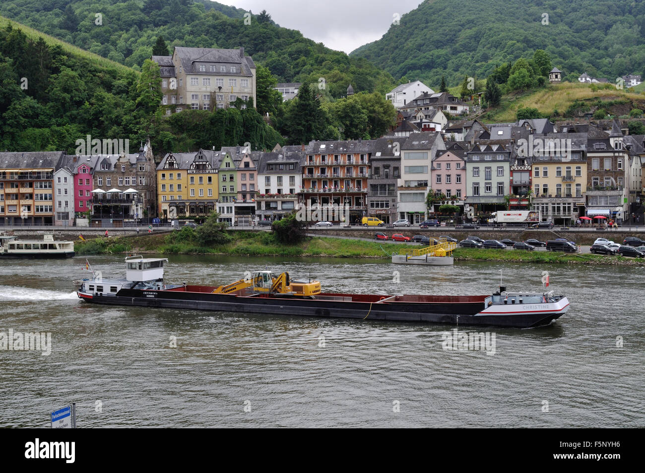 River dredger Christine travels down the Moselle River past Cochem, Germany. Stock Photo