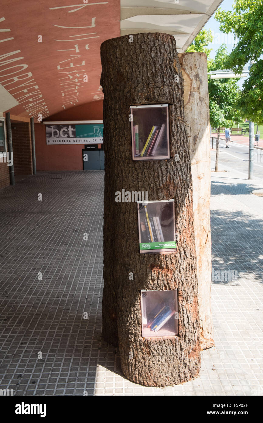 Innovative idea,used,recycled,books being available in a, tree, outside, Public library,Terrassa a city, in Barcelona province,Catalonia,Spain. Stock Photo
