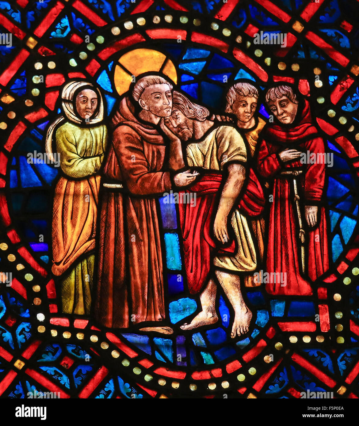 LEON, SPAIN - AUGUST 12, 2014: Stained Glass window depicting a Christian Saint hugging Christ in the Cathedral of Leon Stock Photo