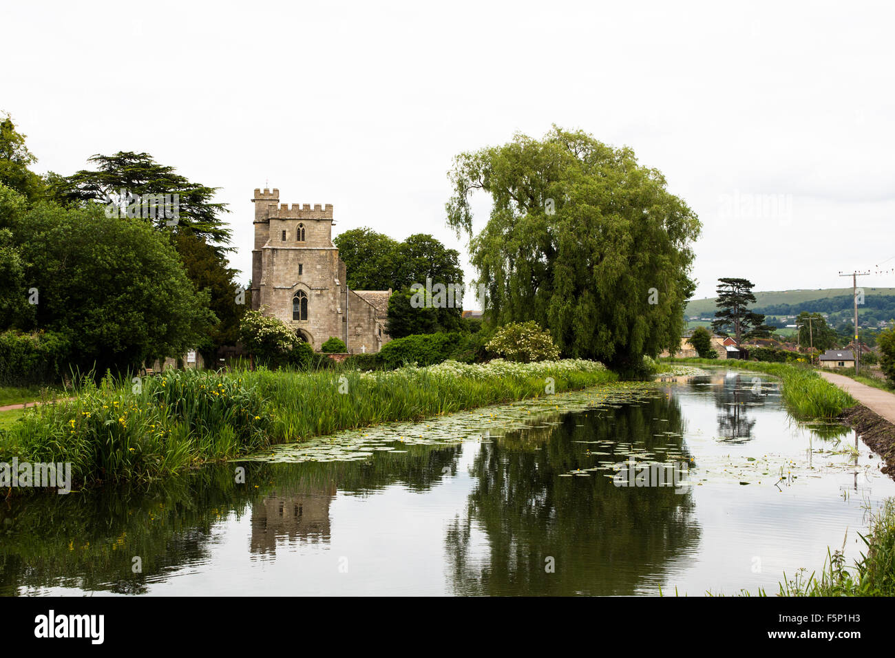 The Severn Thames canal in Stonehouse, Gloucestershire - near Stroud with the the Parish Church of Saint Cyr Stonehouse. Stock Photo