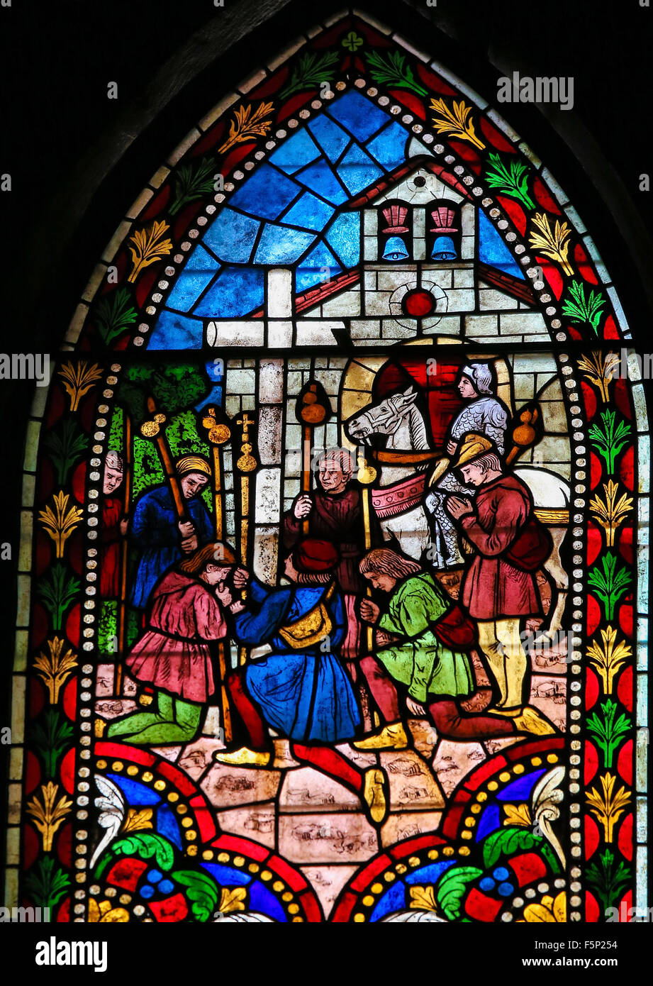 Stained Glass window depicting Pilgrims on the Road of Saint James kneeling at a Cross in the Cathedral of Leon, Spain Stock Photo