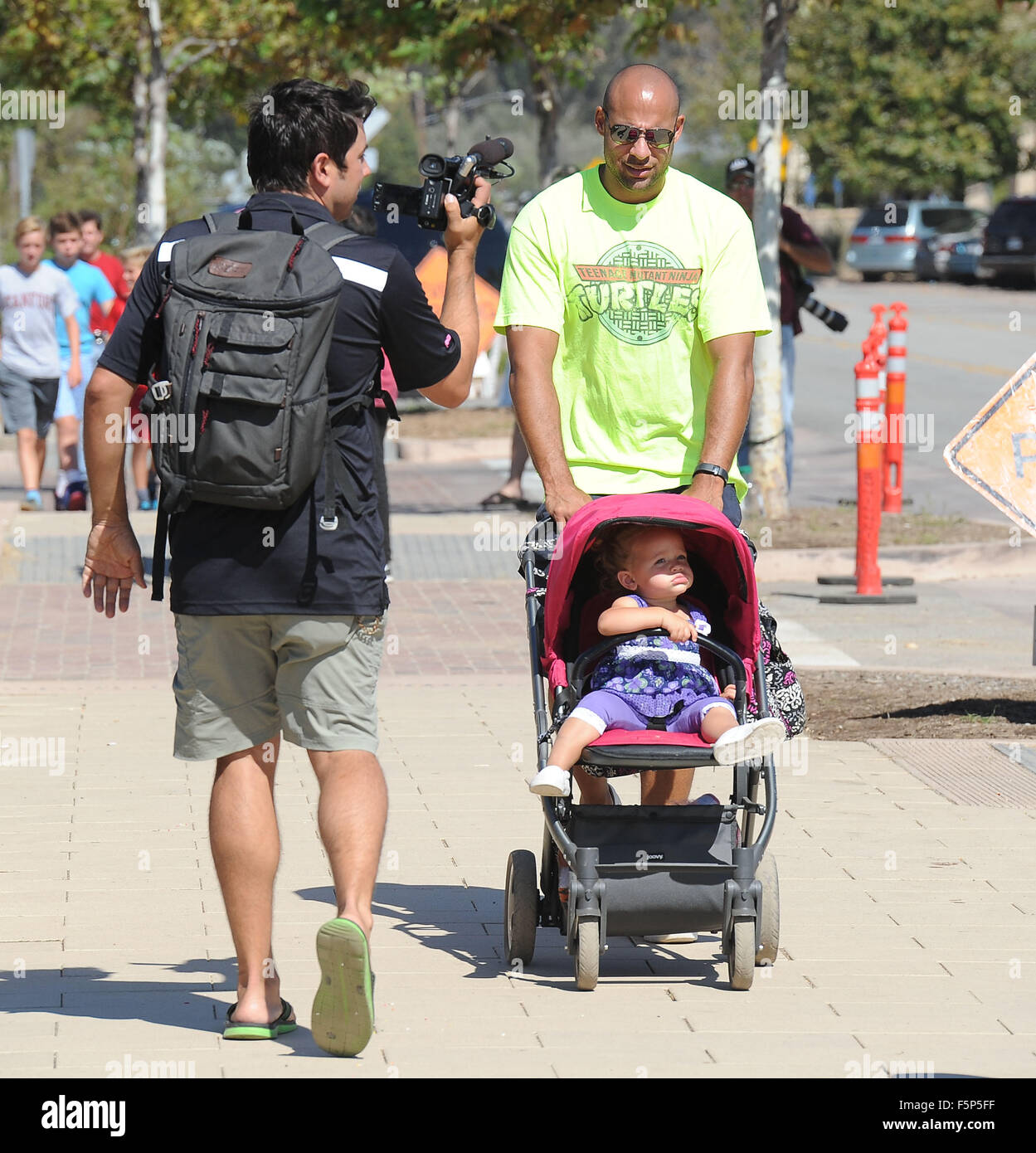 Hank Baskett does an impromptu interview while strolling with daughter Alijah Mary Baskett  Featuring: Hank Baskett Alijah Mary Baskett Where: Los Angeles, California, United States When: 06 Sep 2015 Stock Photo