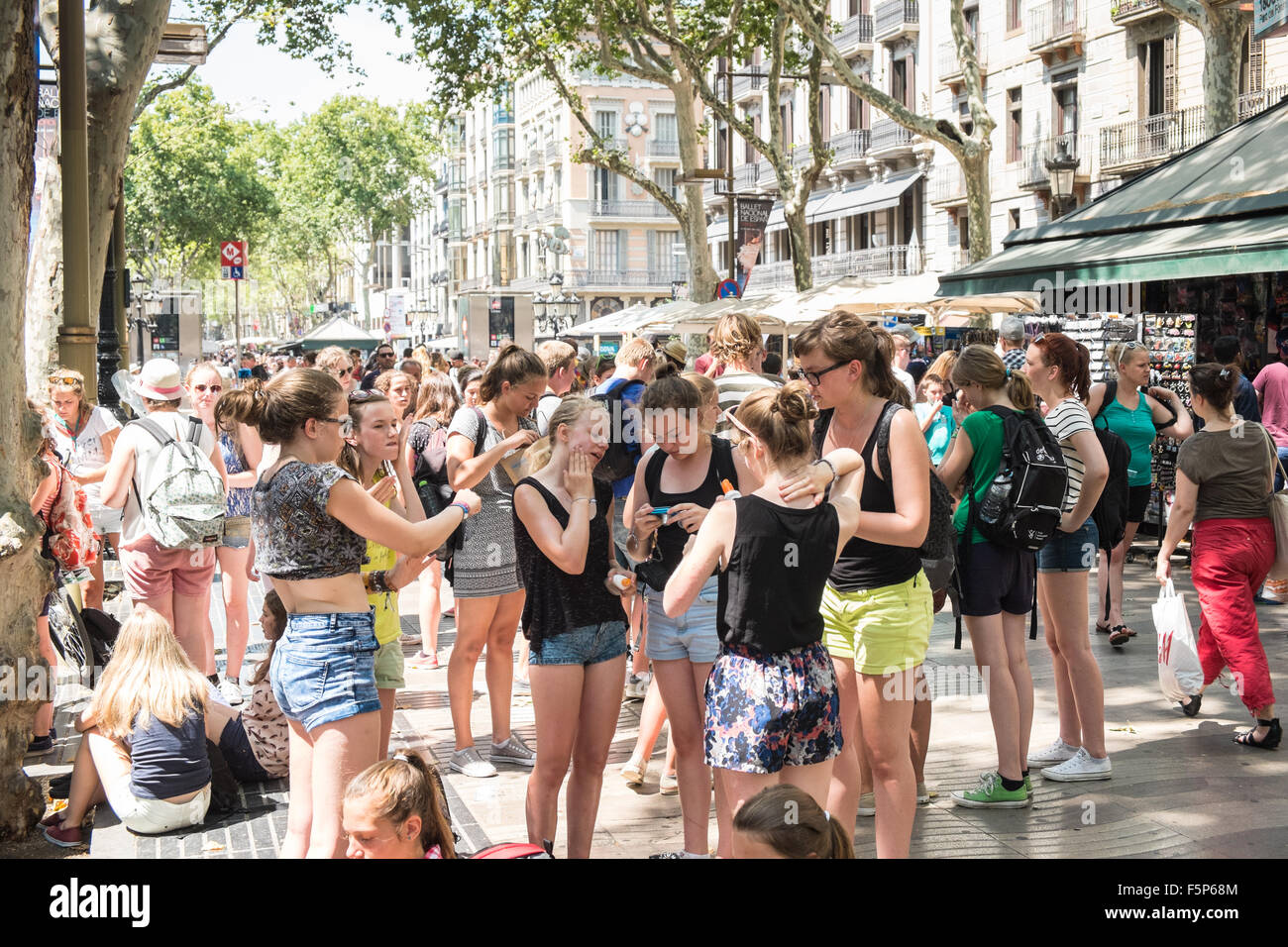 Teenagers,teens,girls,young youths in shorts along La Rambla, La Ramblas,Barcelona,Catalonia,Spain. Stock Photo