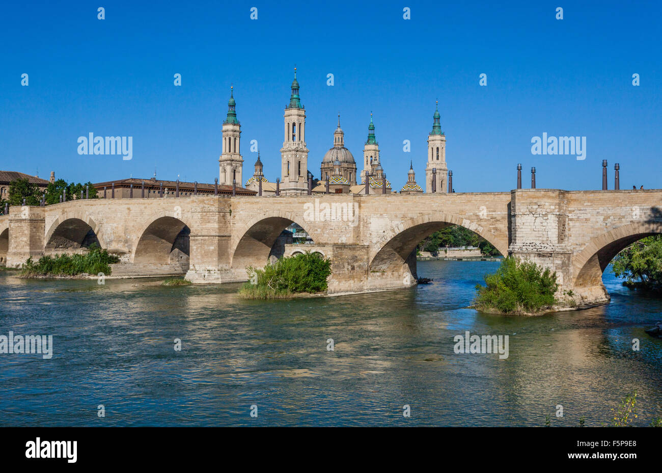 Spain, Aragon, Zaragoza, view of the Baroque style Basilica-Cathedral of Our Lady of the Pillar across the Ebro River with Puent Stock Photo