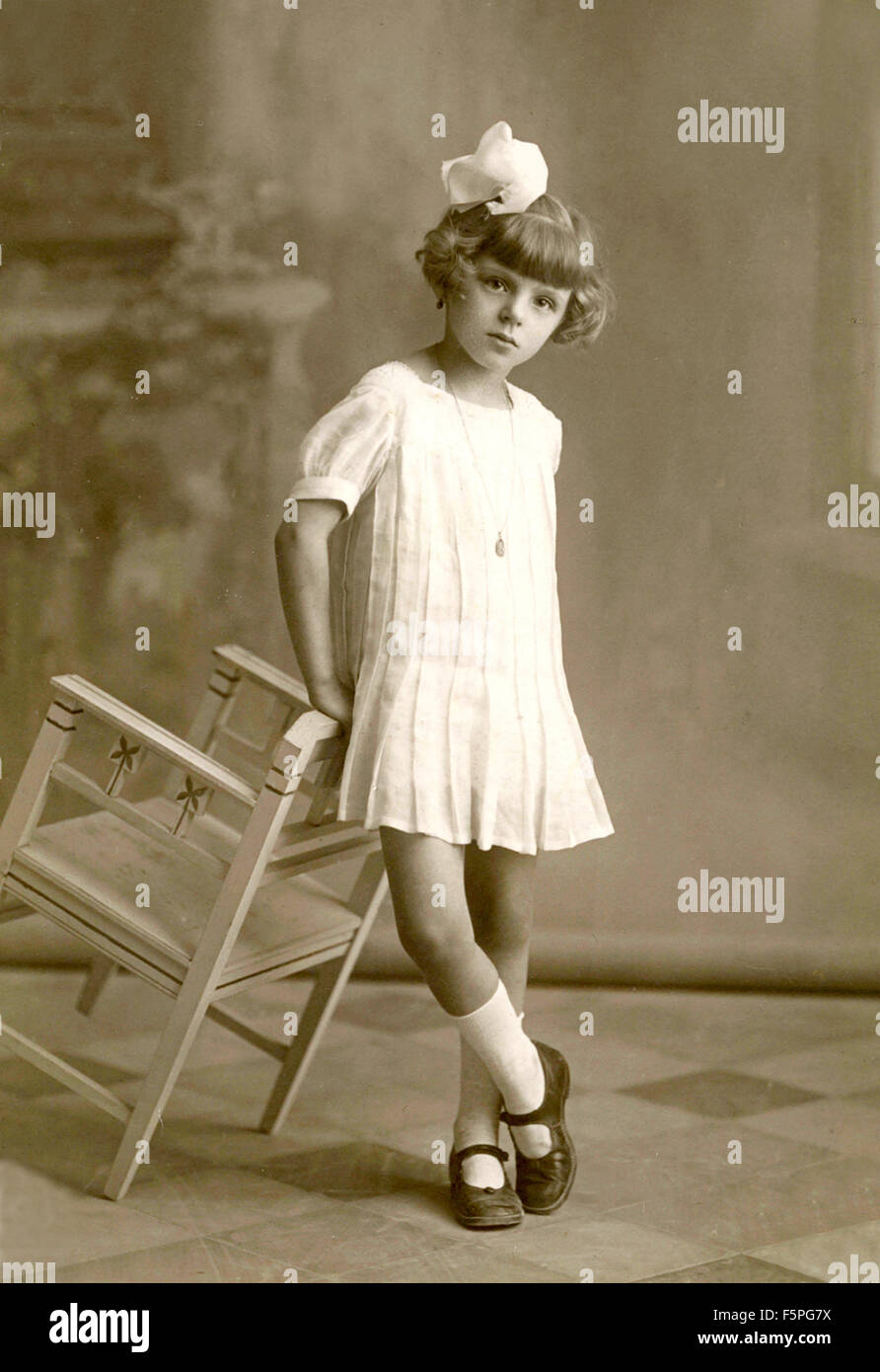Portrait of a girl with dress and white bow, Italy Stock Photo - Alamy