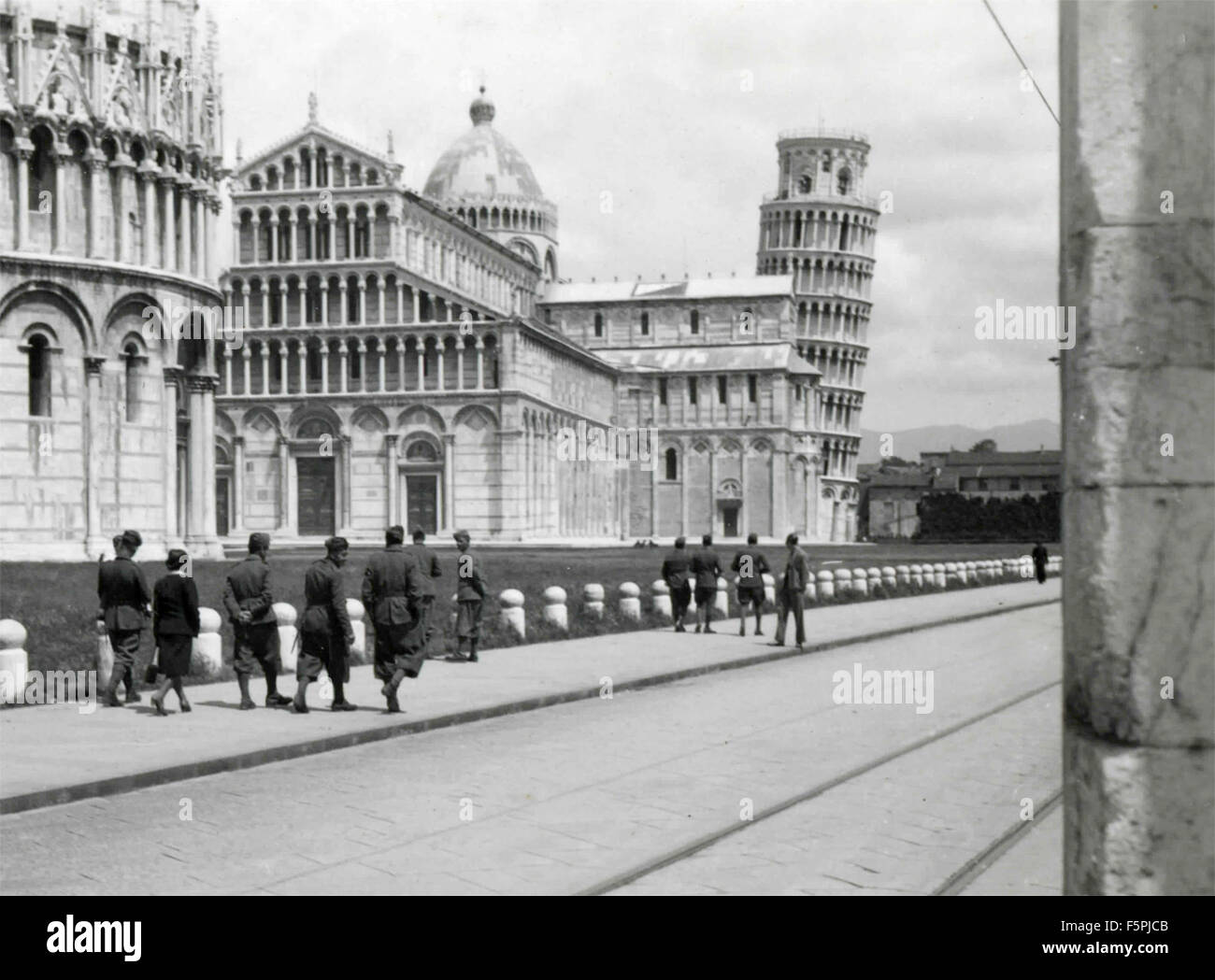Soldiers walking near the Baptistery, the Cathedral and the Tower of Pisa, Italy Stock Photo