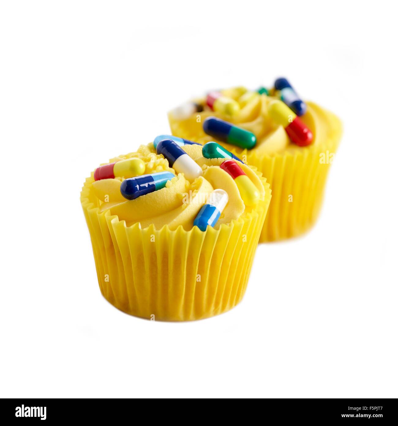 Diet pills, conceptual image. Cup cakes with capsules on the top. Stock Photo