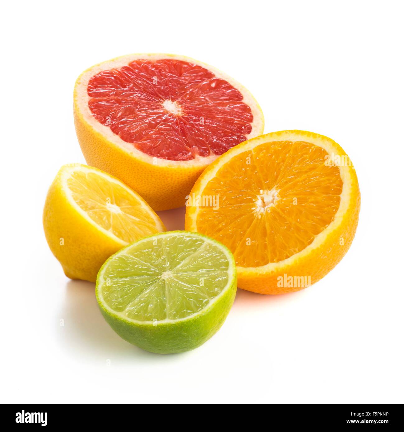 Citrus fruit halves against a white background. Stock Photo