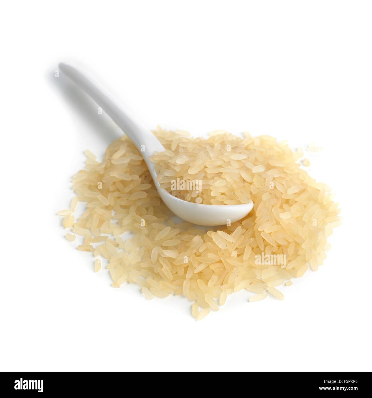 Rice and a spoon against a white background Stock Photo - Alamy