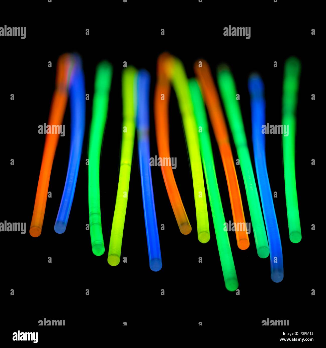 Glow sticks against a black background. Stock Photo