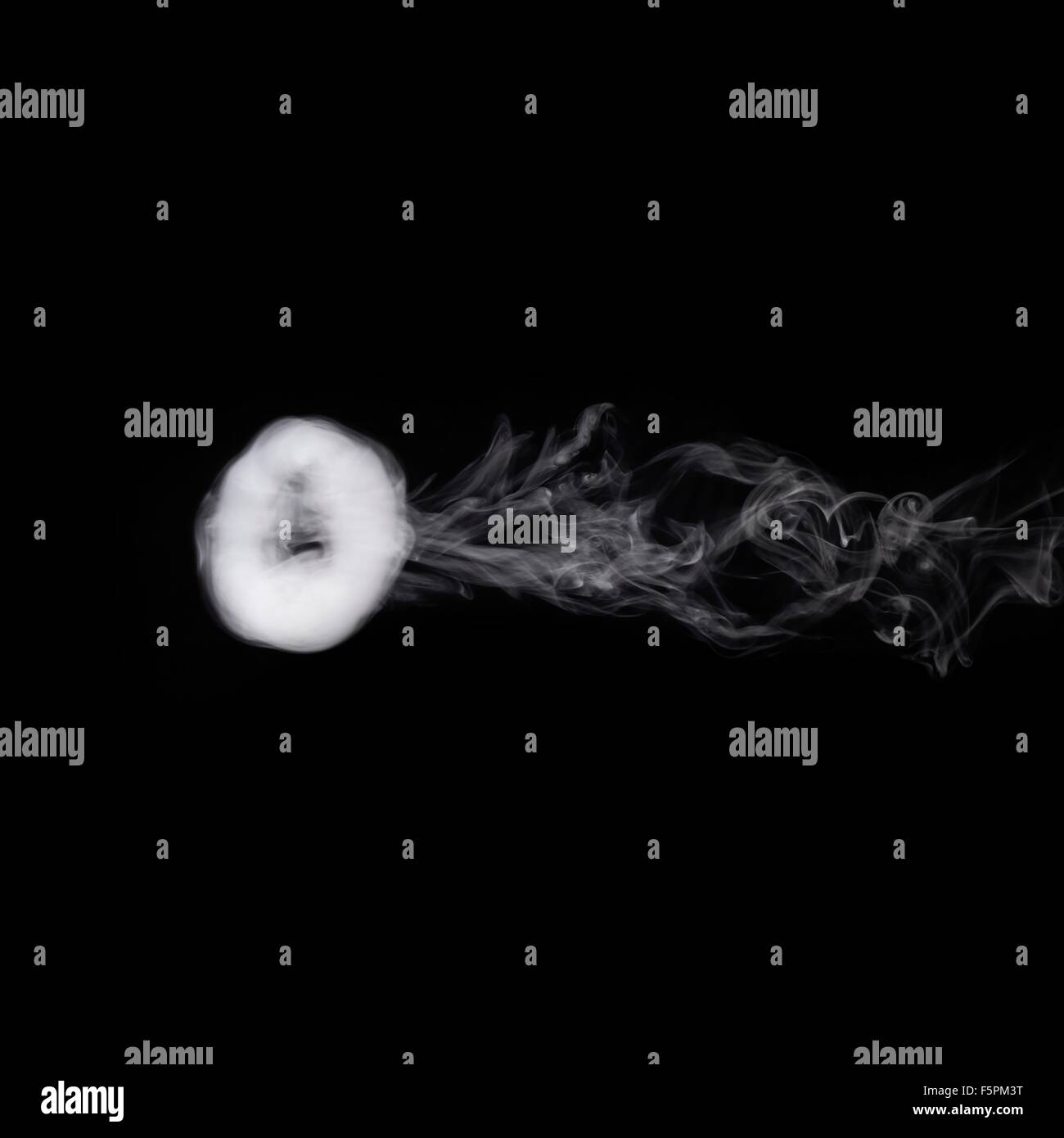 Smoke ring. This is a poloidal (rotating) vortex flow that is stable for considerable distances in still air. The rotating flow Stock Photo