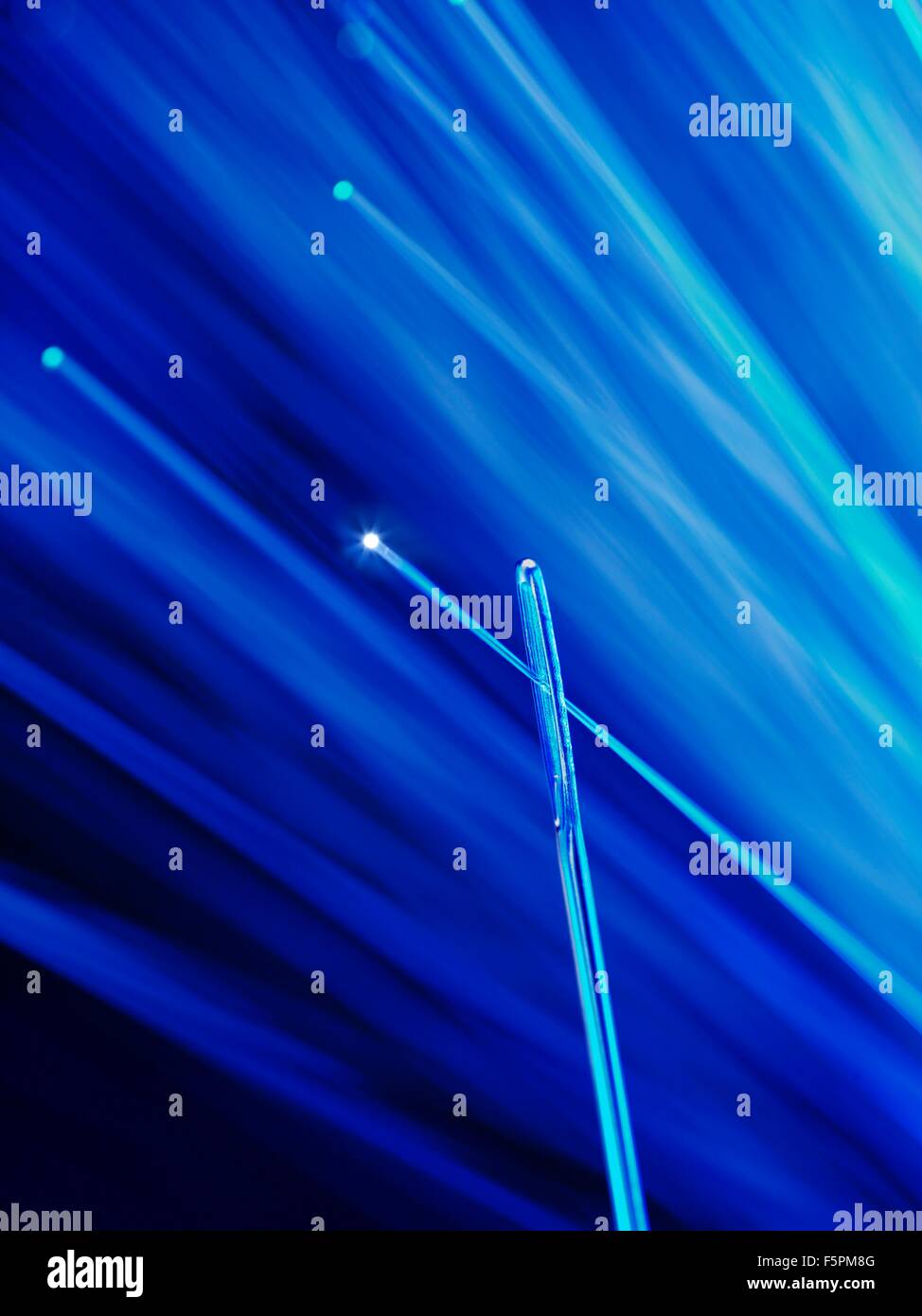 Fibre optic being thread through a needle, close up Stock Photo - Alamy