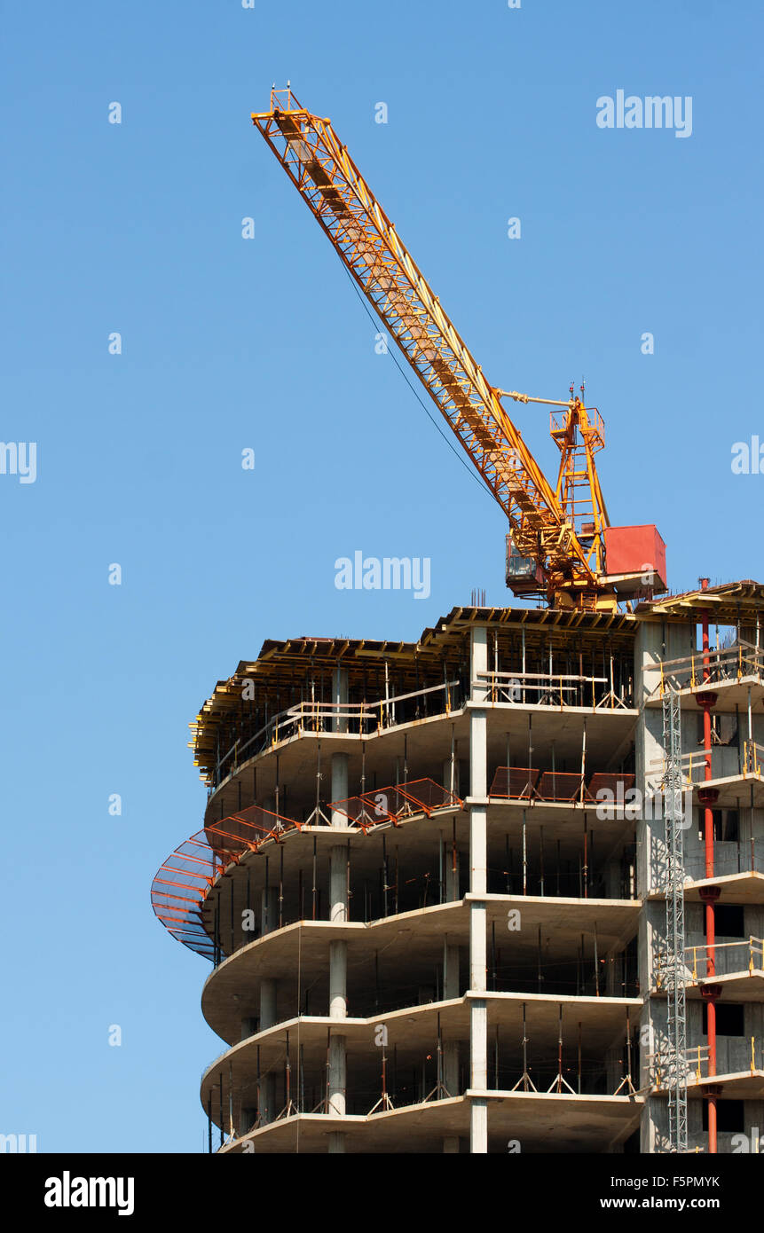 Construction of modern building against blue sky Stock Photo - Alamy