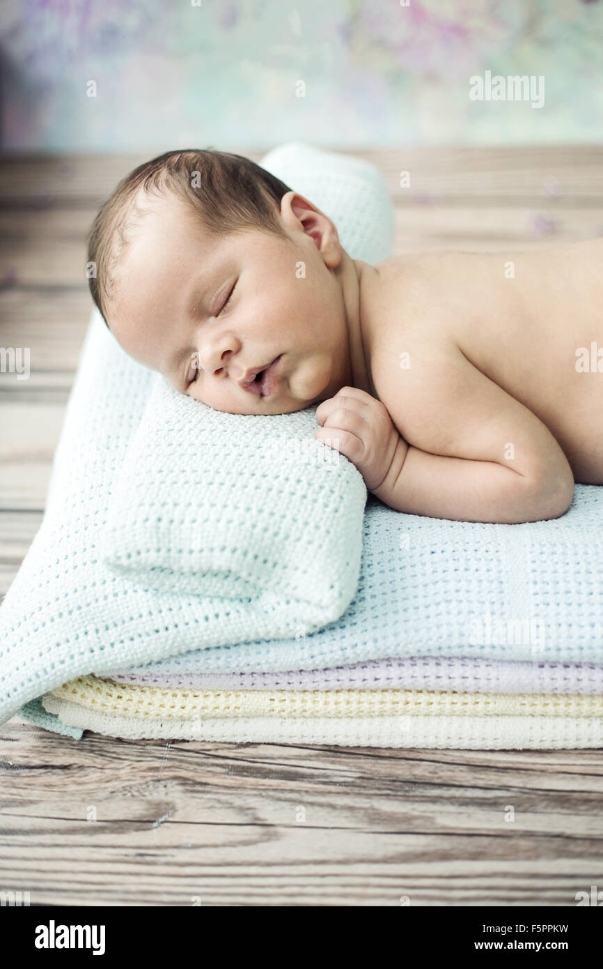 Cute newborn child sleeping on the soft blanket Stock Photo