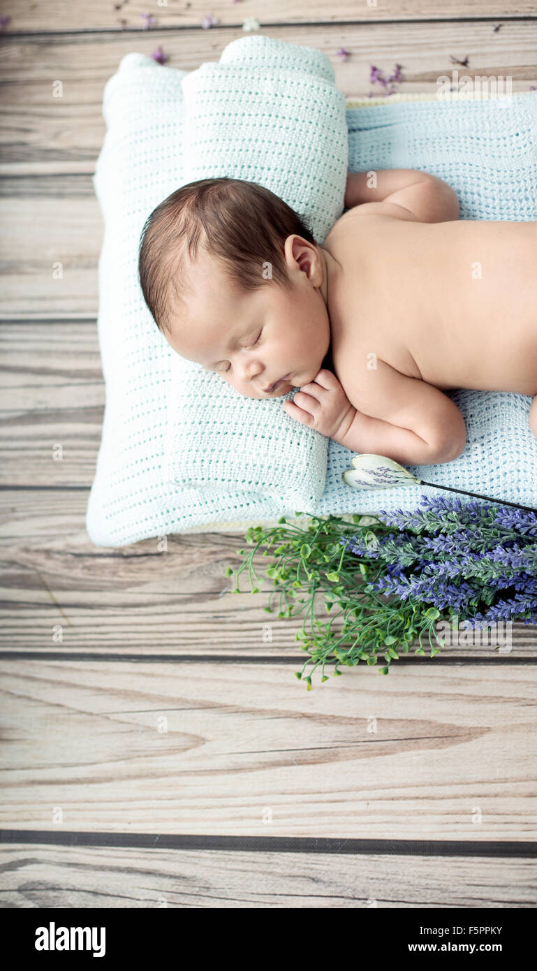Cute little child sleeping on the blue blanket Stock Photo