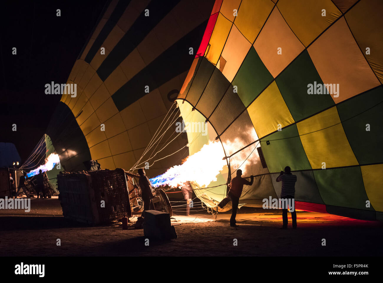 Gas burner filling hot air balloons in the early morning dawn Stock Photo