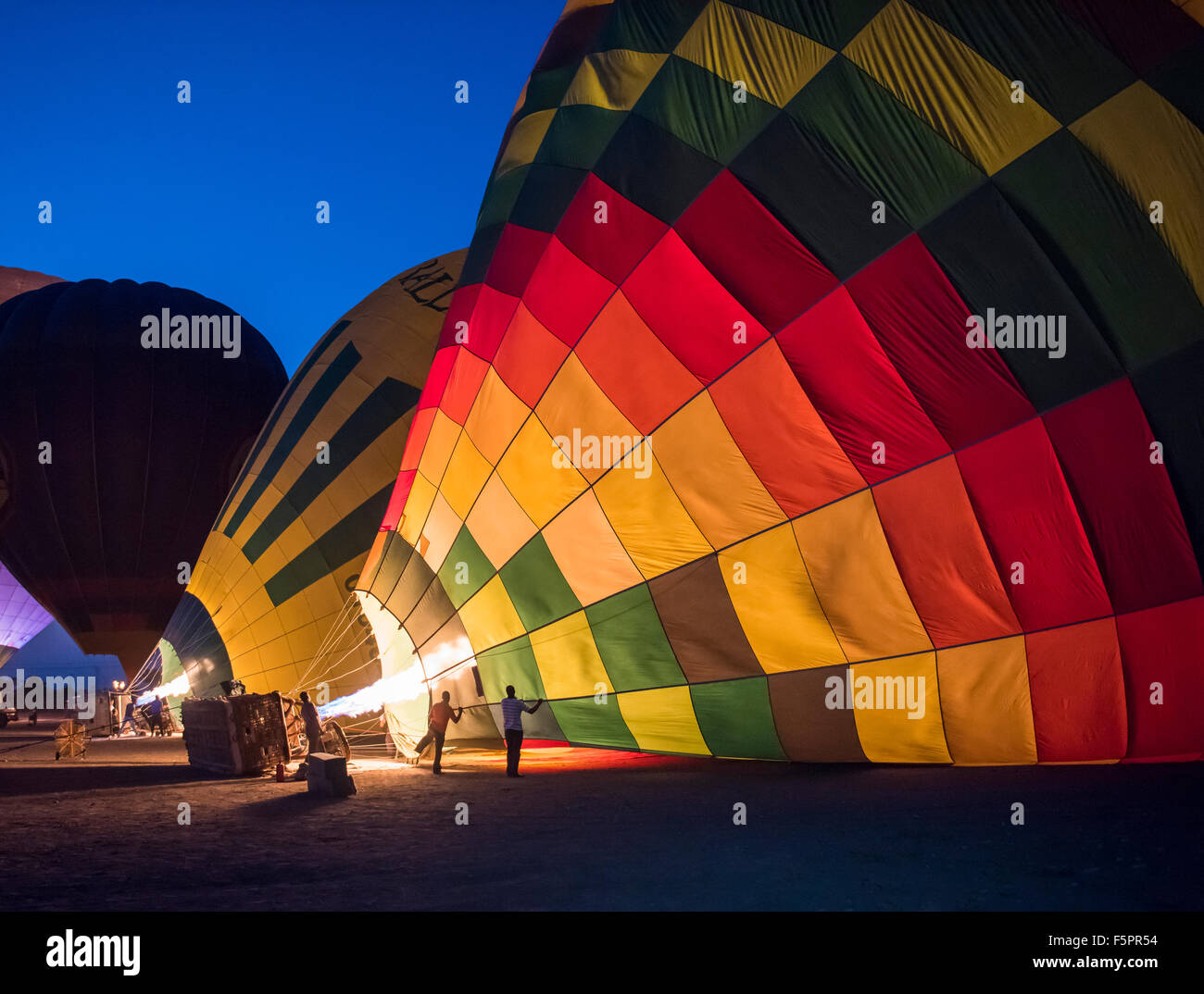 Gas burner filling hot air balloons in the early morning dawn Stock Photo
