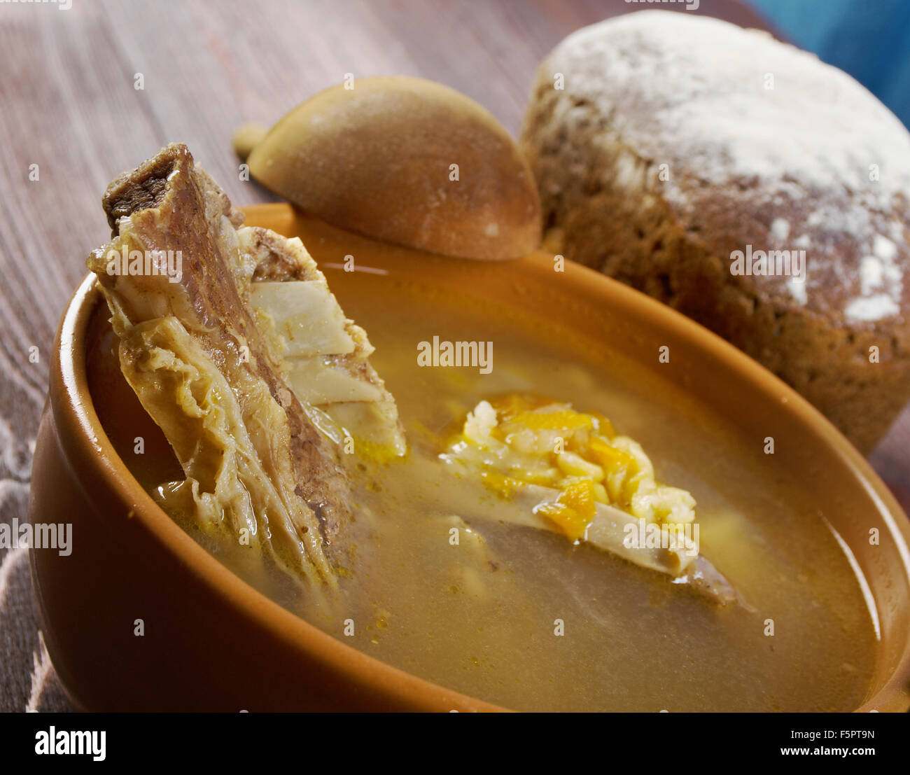 Pea soup with beef ribs  and farmhouse bread,edible greens .farmhouse kitchen Stock Photo