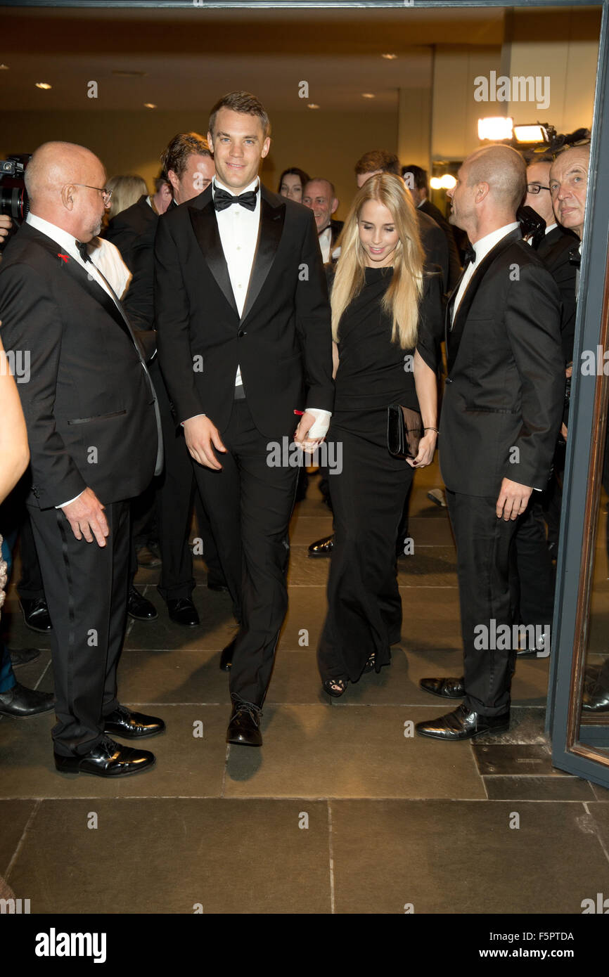 Berlin, Germany. 7th Nov, 2015. Germany goalkeeper Manuel Neuer and girlfriend Nina arrive at the 22nd opera gala for the Deutsche Aids-Stifung (German AIDS foundation) in Berlin, Germany, 7 November 2015. Around 2000 guests and several celebrities attended. PHOTO: JOERG CARSTENSEN/DPA/Alamy Live News Stock Photo