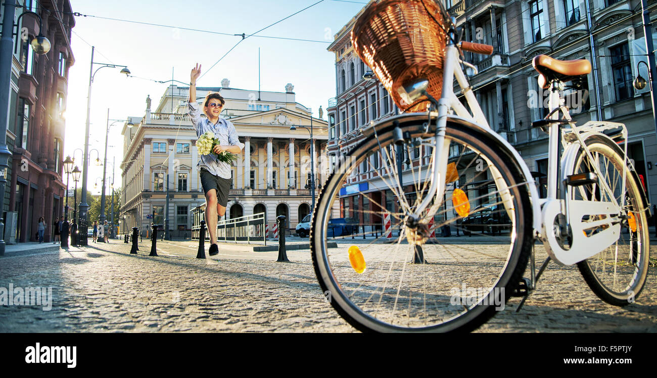 Portrait of a running man holding roses Stock Photo - Alamy