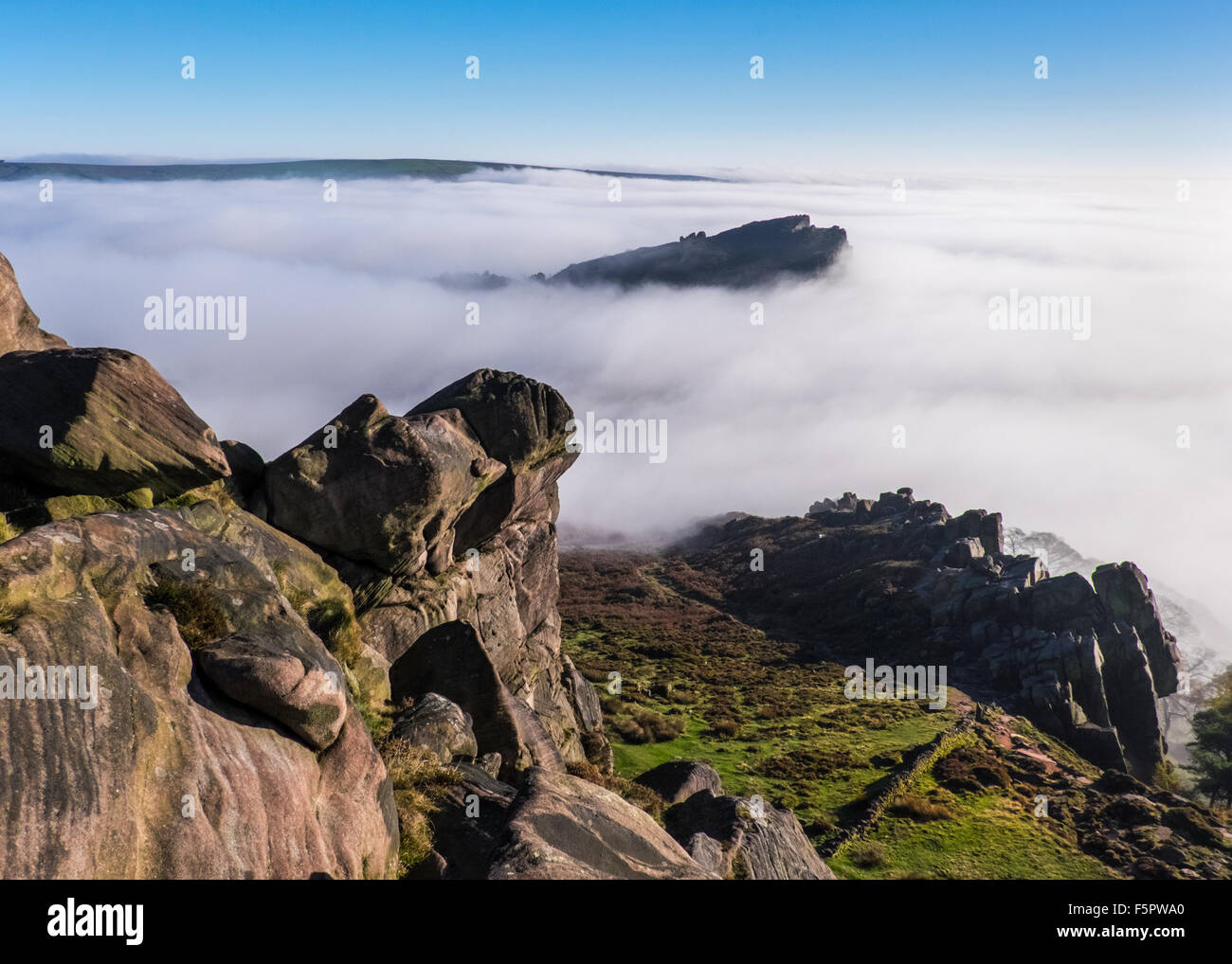 Hen Cloud peeps above a temperature inversion in the Peak District National Park, UK, viewed from The Roaches Stock Photo