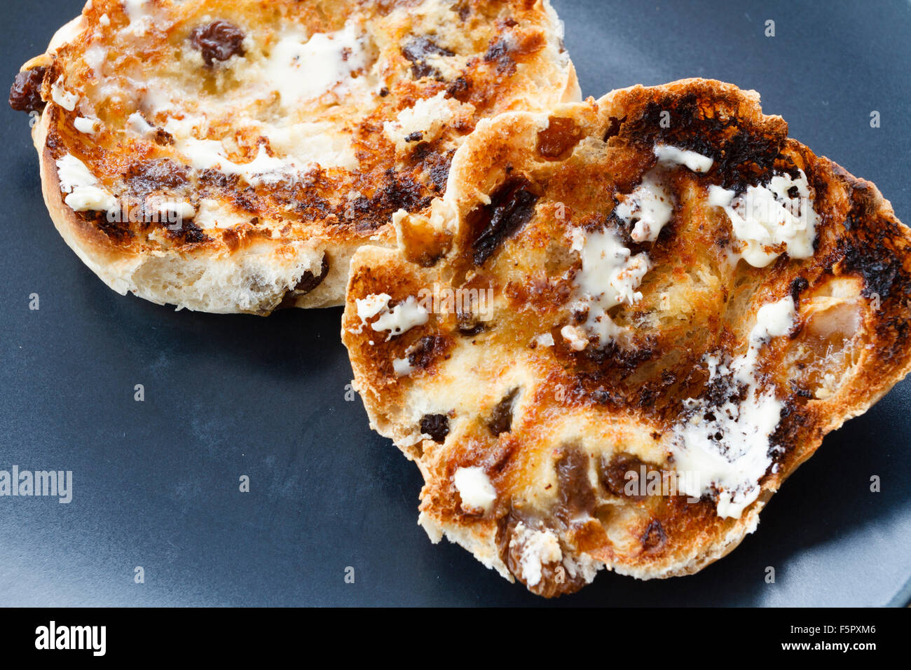 Hot buttered, toasted tea cakes on a blue plate Stock Photo Alamy