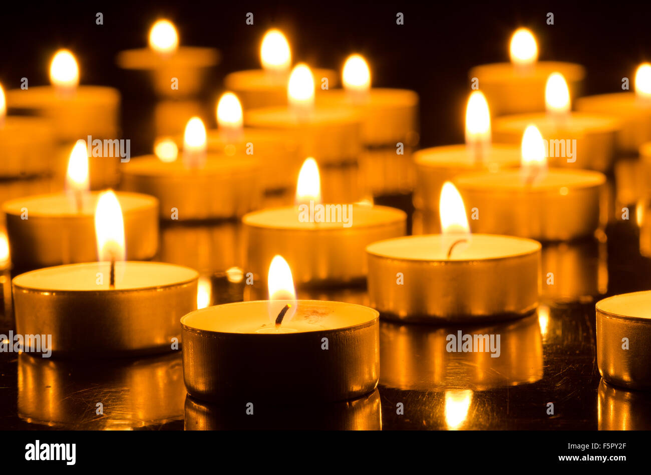 closeup to burning candles in darkness Stock Photo
