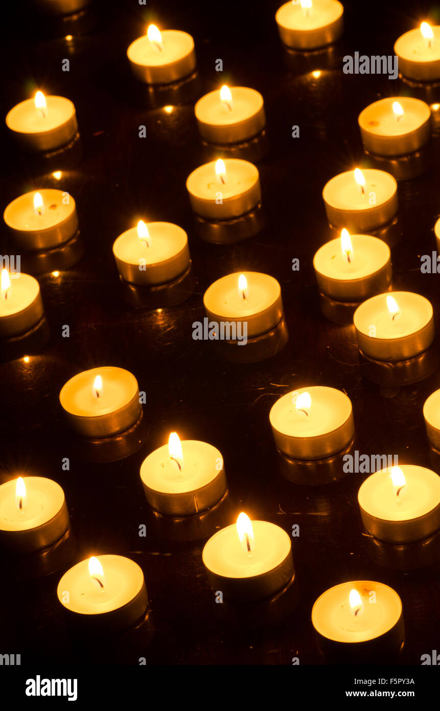 closeup to burning candles in darkness Stock Photo