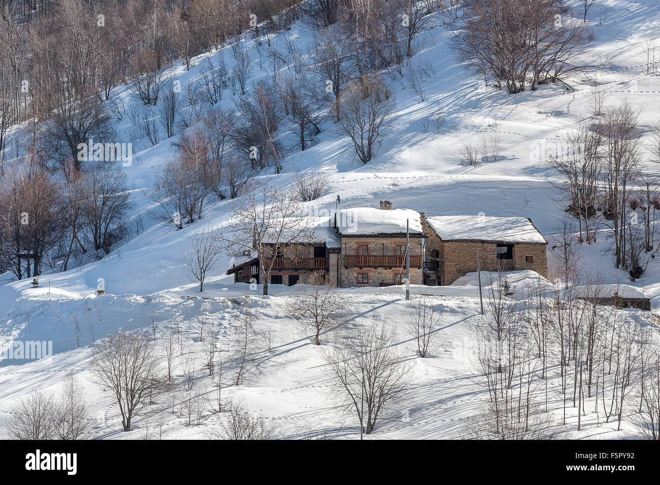 Rural stone house on snowy slope in Piedmont, Northern Italy Stock ...