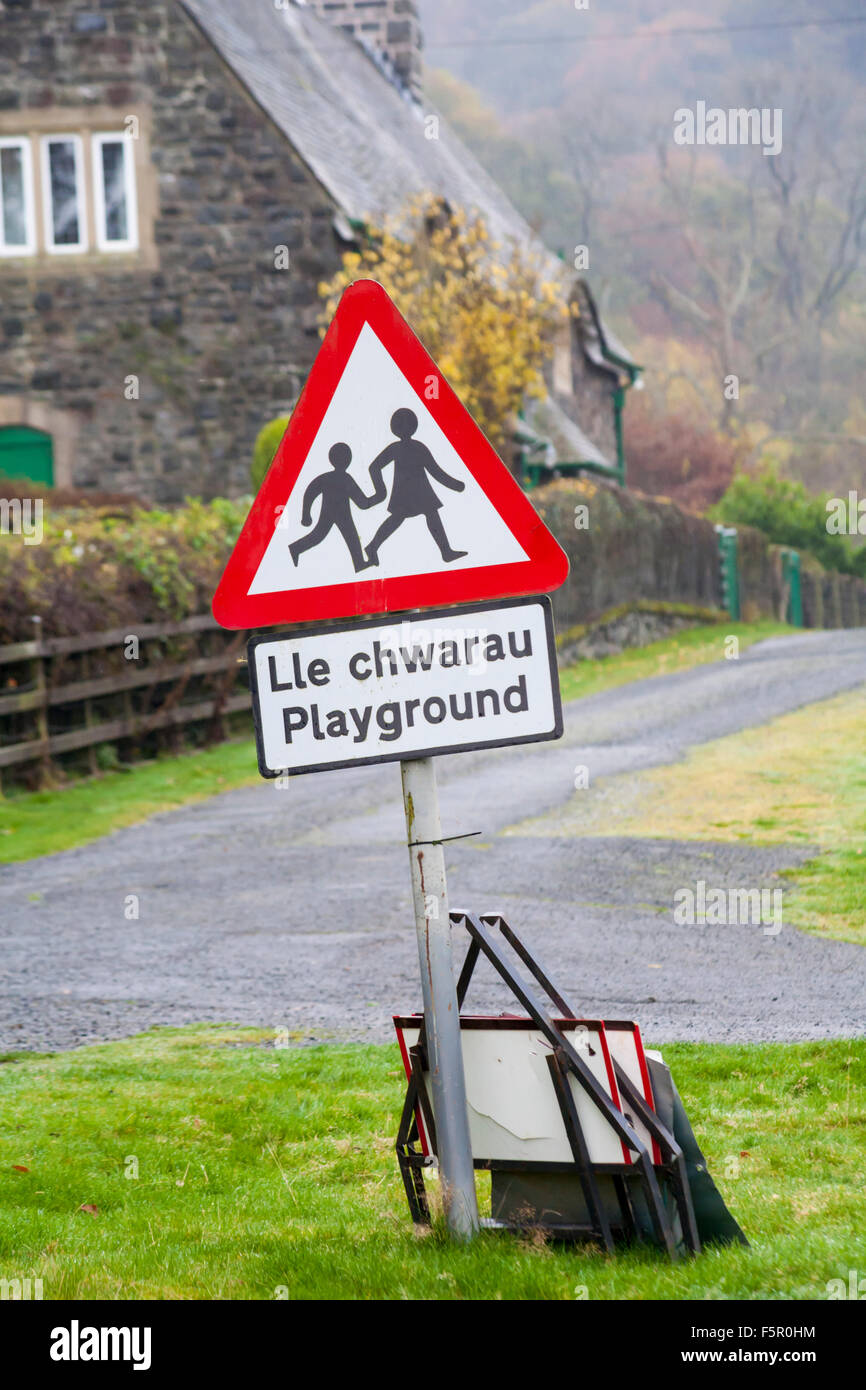 Playground sign, children crossing road sign, at Elan village in Elan Valley, Powys, Mid Wales, UK in November - triangular road sign triangle Stock Photo