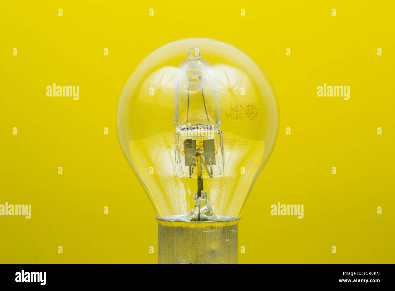 A light bulb on a yellow background Stock Photo - Alamy