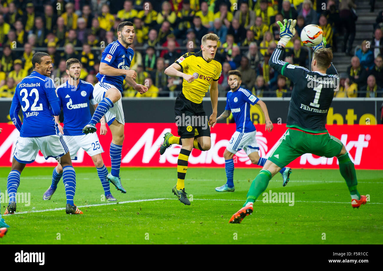 Dortmund's Matthias Ginter (C) heads the goal to make it 2:1 past Schalke's Sead Kolasinac (l) and Schalke's goalkeeper Ralf Fährmann (r), while Schalke's Joel Matip (l) is unable to intervene, during the German Bundesliga football match between Borussia Dortmund and FC Schalke 04 at the Signal-Iduna-Park in Dortmund, Germany, 8 November 2015. PHOTO: GUIDO KIRCHNER/DPA (EMBARGO CONDITIONS - ATTENTION: Due to the accreditation guidelines, the DFL only permits the publication and utilisation of up to 15 pictures per match on the internet and in online media during the match.) Stock Photo