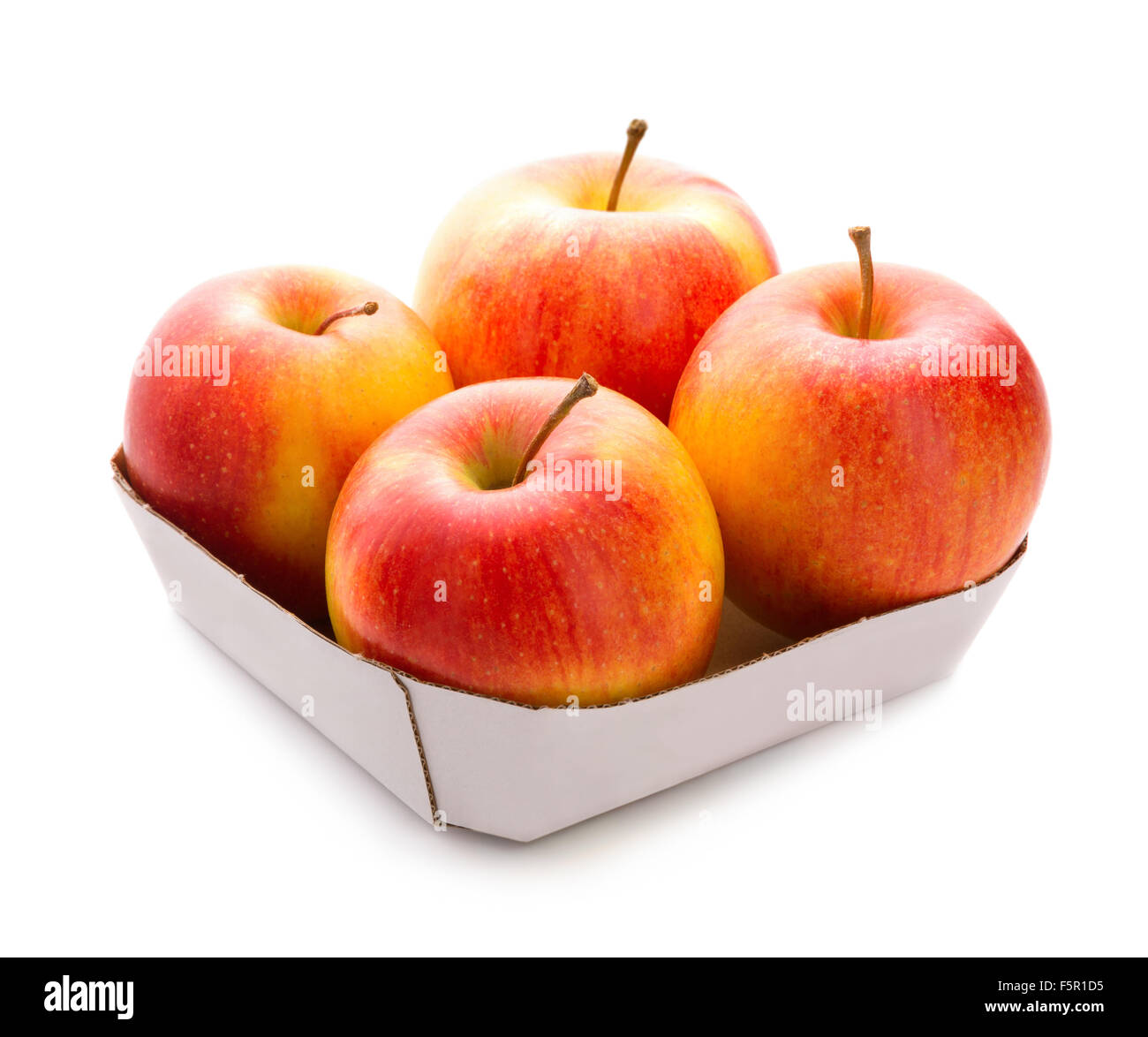 Four apples in box. Isolated over white background. Fresh fruit. Stock Photo