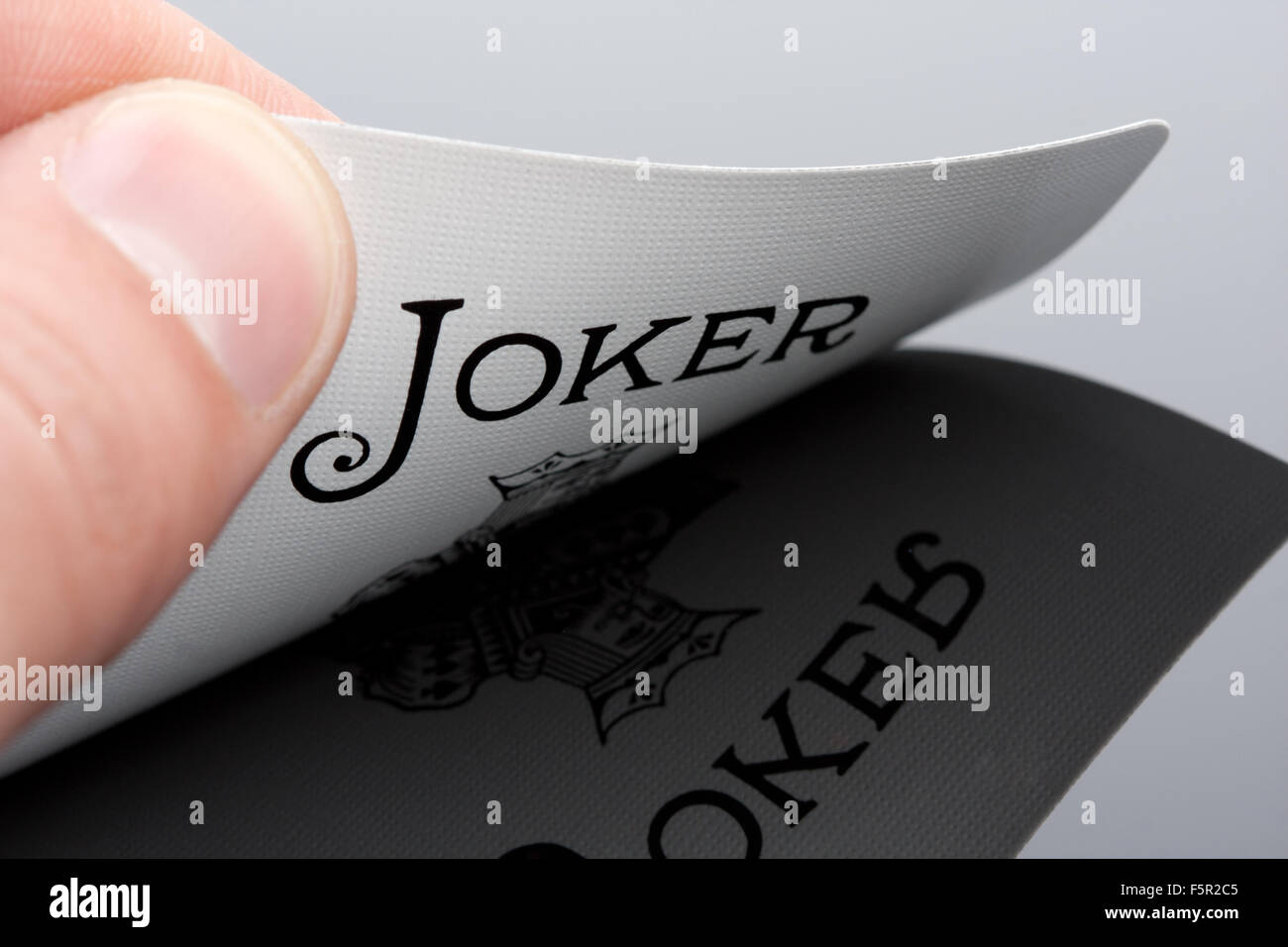 Close-up of Joker card in palm of hand Stock Photo