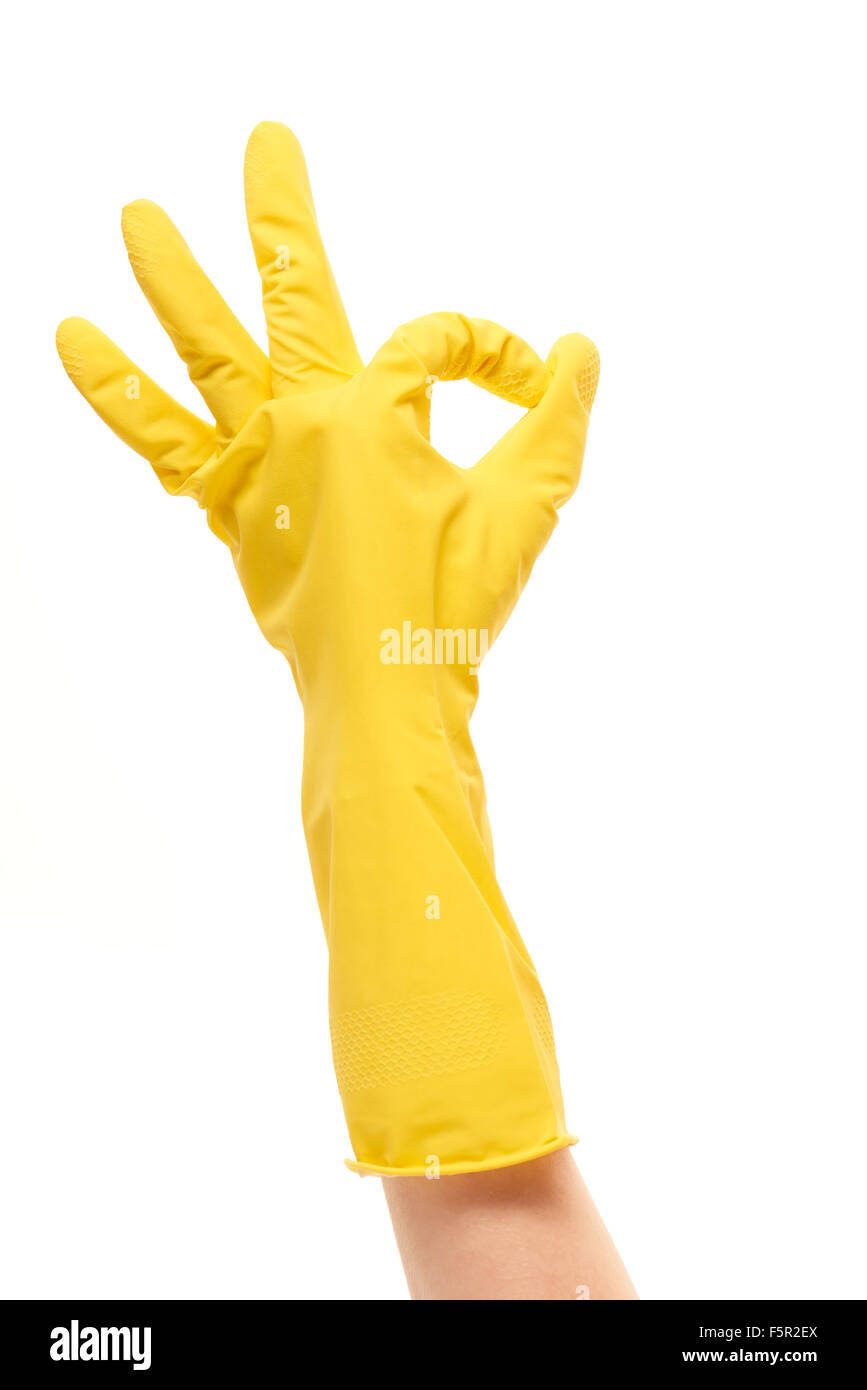 Close up of female hand in yellow protective rubber glove showing OK ...