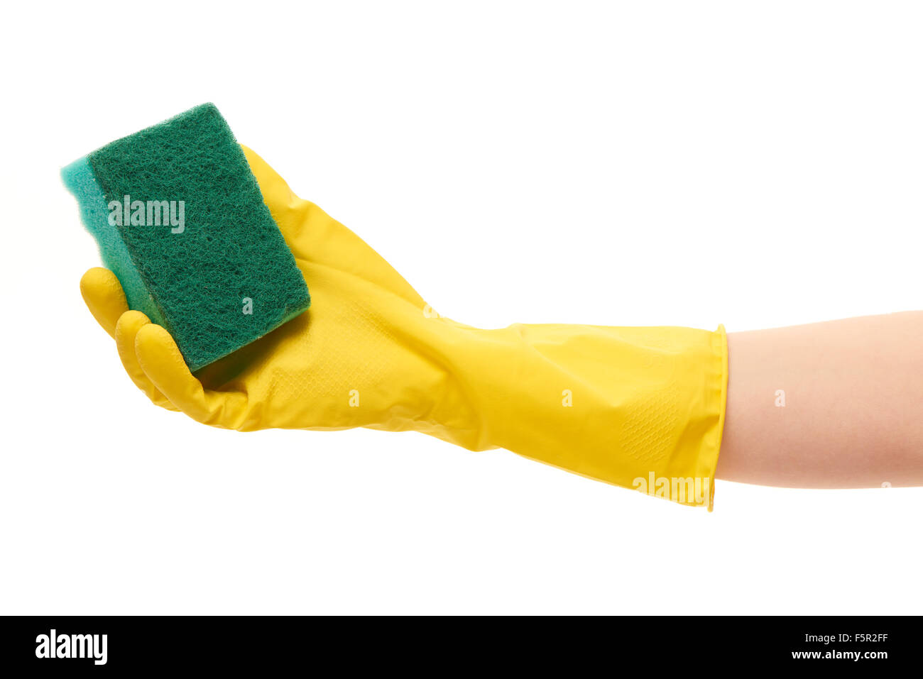Close up of female hand in yellow protective rubber glove holding green ...