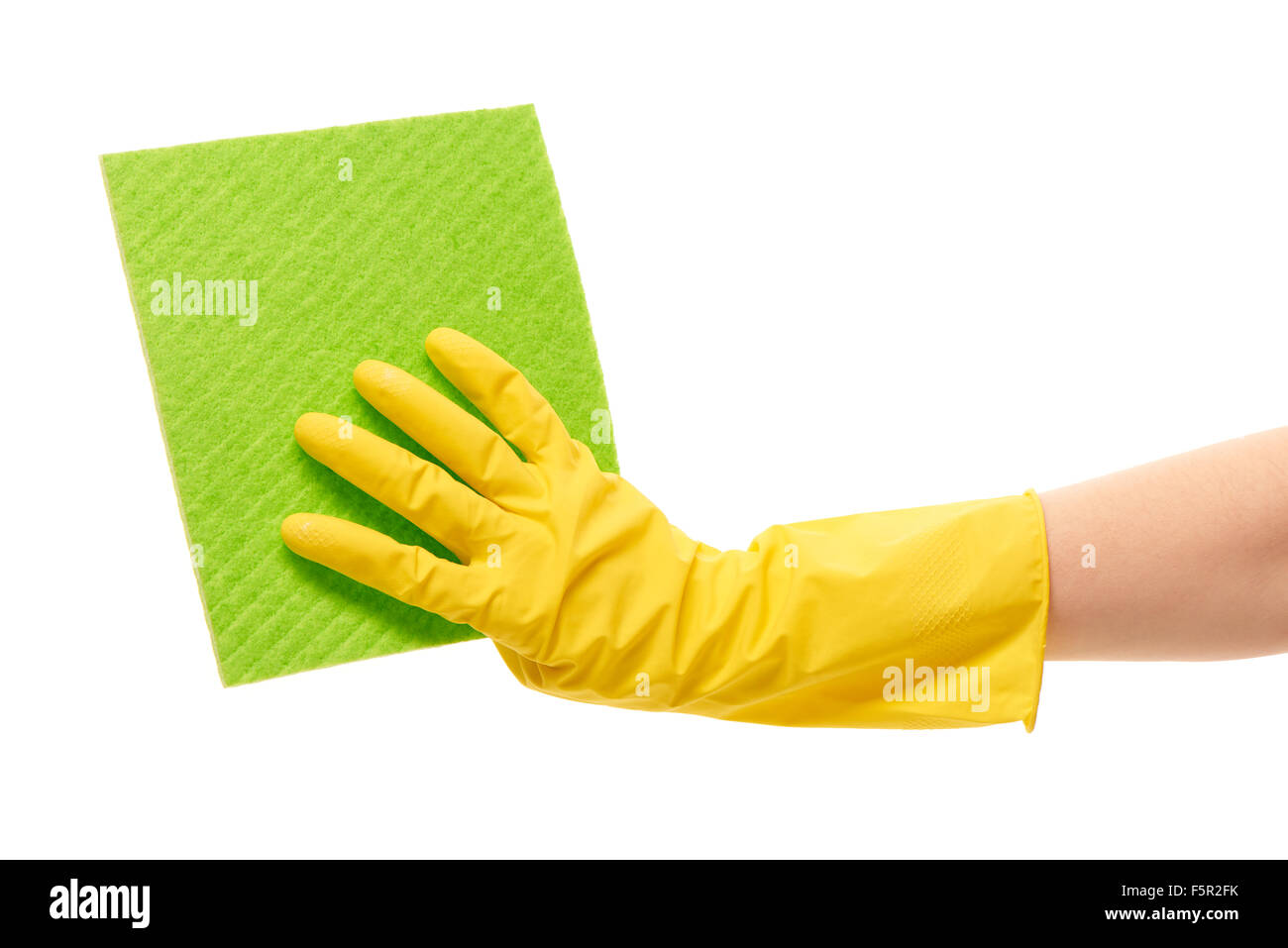 Close up of female hand in yellow protective rubber glove holding green ...