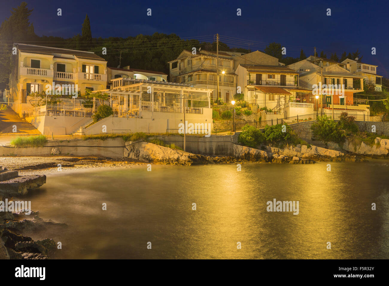 Villas overlooking the sea at dawn in Kassiopi. Corfu, Greece. Stock Photo
