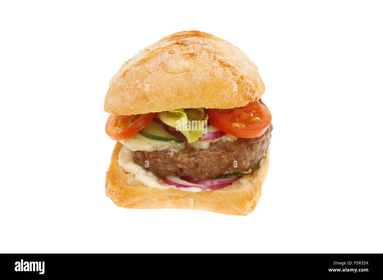 Cheese burger with salad in a sourdough bun isolated against white Stock Photo
