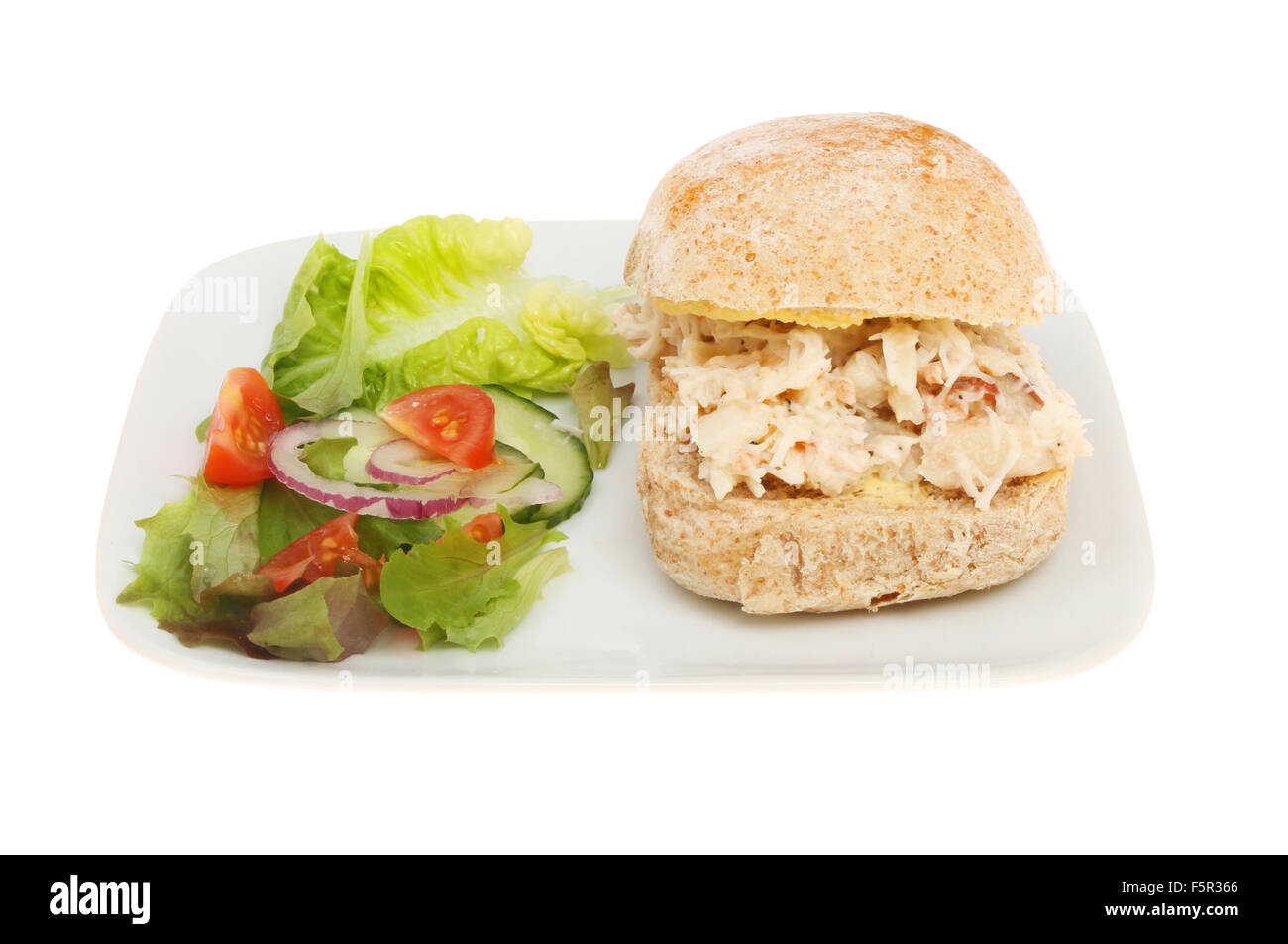 Crab roll with salad on a plate isolated against white Stock Photo