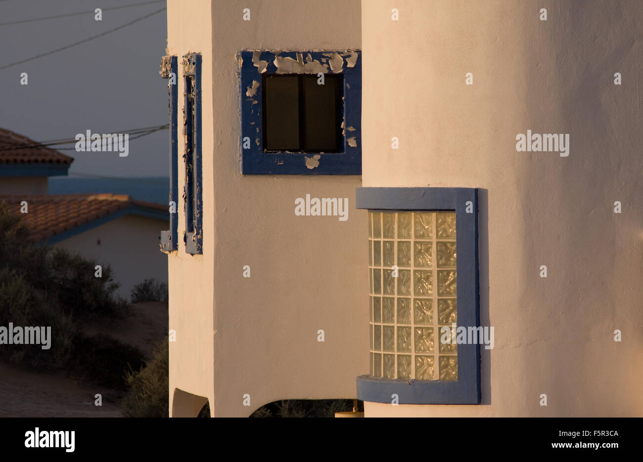 Window frames on beach house have pealing blue paint in early morning sun at Puerto Penasco Mexico  (Rocky Point). Stock Photo