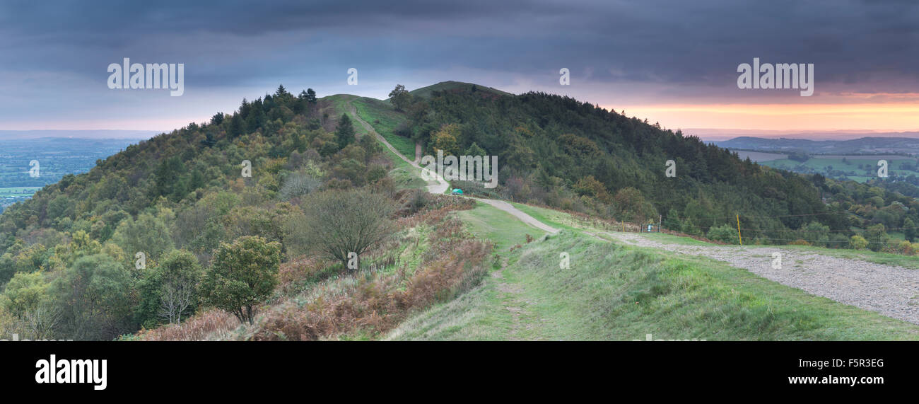 The path on Perseverance Hill, Malvern, leads towards Jubilee Hill while the sun sets over herefordshire. Stock Photo