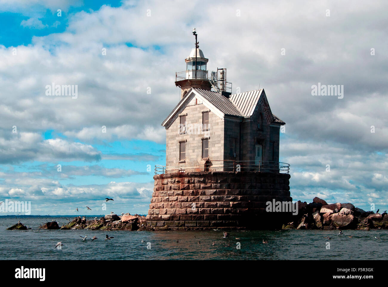 Middleground lighthouse, with its unique stone construction protects mariners from the dangerous Stratford Shoal in between Connecticut and New York. Stock Photo