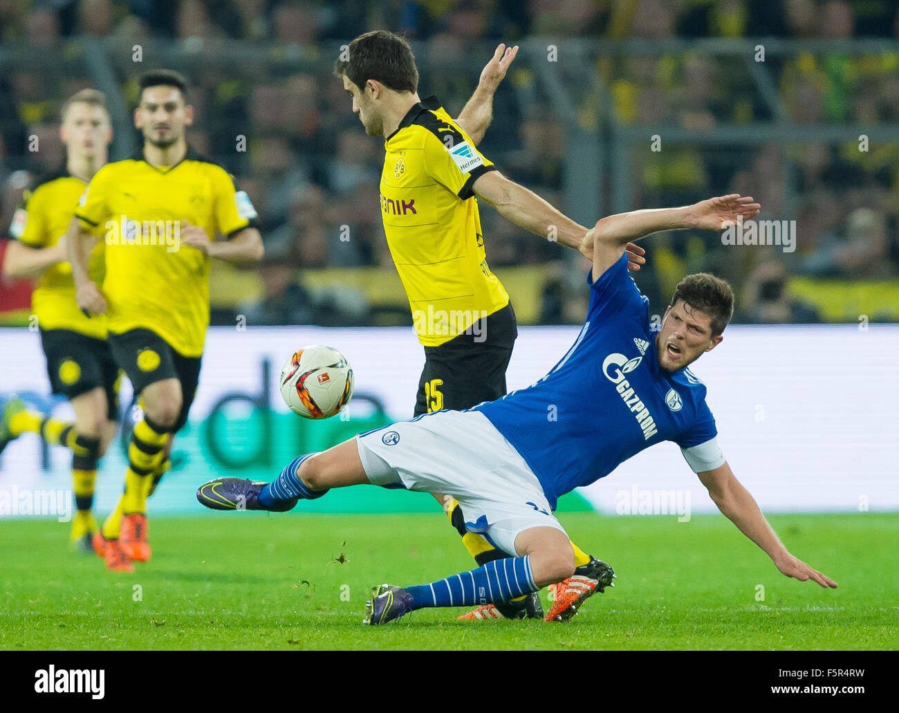 Dortmund, Germany. 8th Nov, 2015. Schalke's Klaas-Jan Huntelaar (r) and Dortmund's Sokratis (l) compete for tha ball during the German Bundesliga football match between Borussia Dortmund and FC Schalke 04 at the Signal-Iduna-Park in Dortmund, Germany, 8 November 2015. PHOTO: GUIDO KIRCHNER/DPA (EMBARGO CONDITIONS - ATTENTION: Due to the accreditation guidelines, the DFL only permits the publication and utilisation of up to 15 pictures per match on the internet and in online media during the match.) Credit:  dpa/Alamy Live News Stock Photo