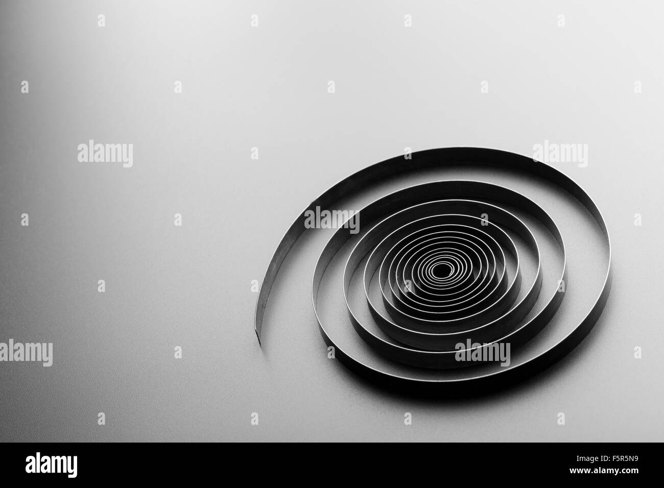 Abstract metallic spiral on grey background Stock Photo Alamy