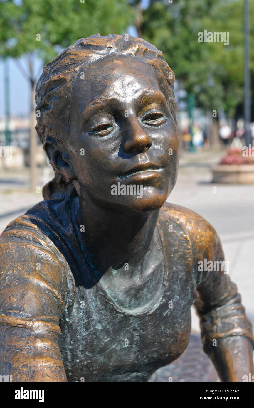 A bronze sculpture of a girl and a dog with a ball in Budapest, Hungary